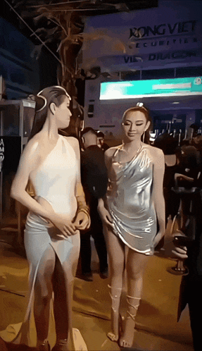 two women standing next to each other in front of a sign that says kong viet