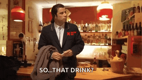 a man in a suit is standing in front of a bar with the words so that drink written below him