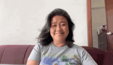 a woman is sitting on a couch wearing a t-shirt that says ' minecraft ' on it