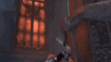 a woman in a superhero costume is standing in a dark room holding a sword .