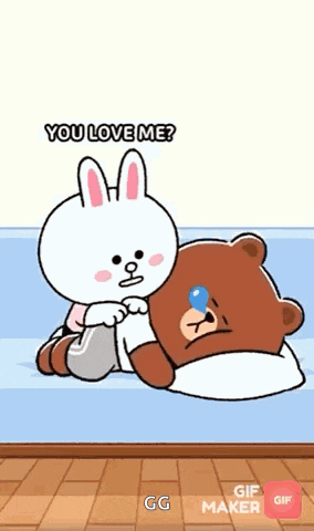 a teddy bear is laying on a bed next to a bunny that says you love me