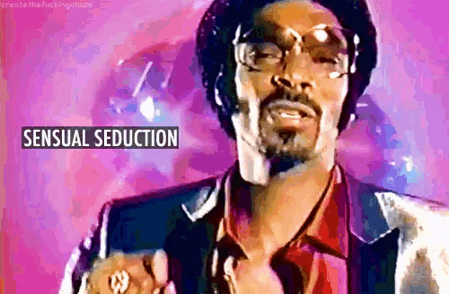 a man with a beard and glasses is standing in front of a pink background with the words sensual seduction on it
