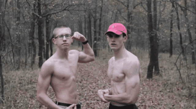 a shirtless man in a red nike hat flexes his muscles