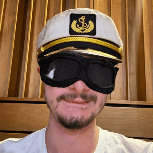 a man wearing a captain 's hat with an anchor on it