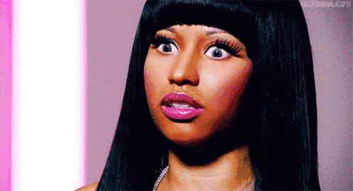 a close up of a woman with a surprised look on her face .