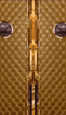 a close up of a gold door with a pattern of x 's