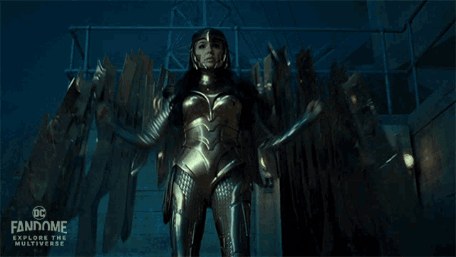 a poster for dc fandome explore the multiverse shows a woman in a golden suit