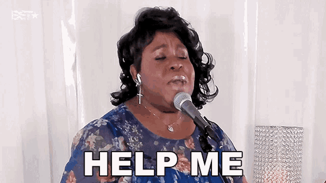 a woman singing into a microphone with the words help me written below her