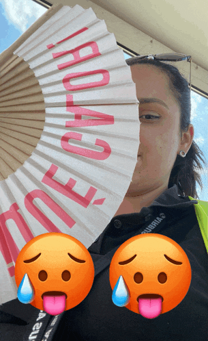 a woman is holding a fan that says " road e "