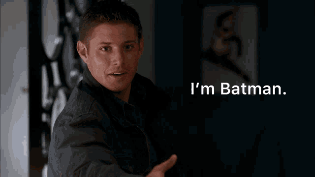 a man with a surprised look on his face and the words i 'm batman behind him