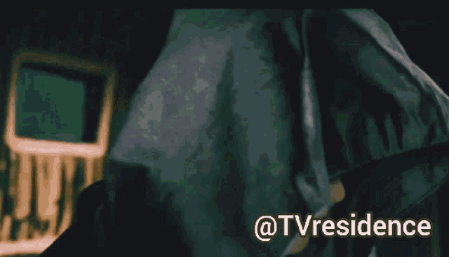 a woman wearing a hooded jacket and white gloves with the words @tvresidence above her