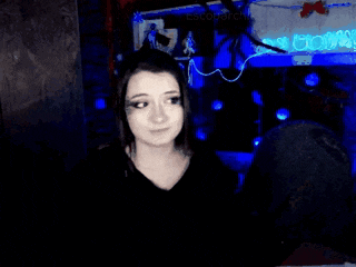 a woman in a dark room with a blue light behind her that says ' escobarch '