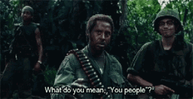 a group of soldiers are standing in the jungle and one of them is asking what do you mean you people