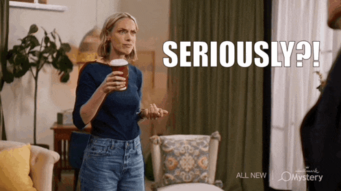 a woman is holding a cup of coffee and says seriously ?