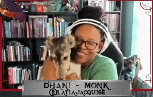 a woman holding a small animal with a sign that says ' dhani monk '