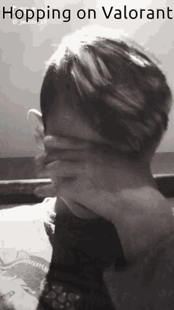 a person covering their face with their hand and the words hopping on valorant above them