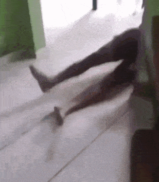 a person laying on the floor with their legs crossed .