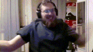 a man with a beard wearing headphones and glasses is dancing