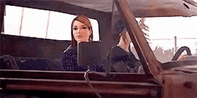 a woman is sitting in the back seat of a truck .