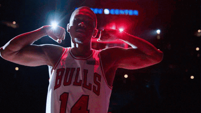 a man wearing a bulls jersey with the number 14 on it