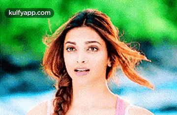 a woman with her hair blowing in the wind .