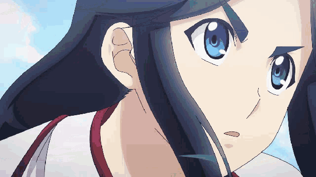 a close up of a girl 's face with a blue eye