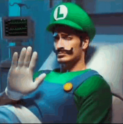 a man in a hospital bed dressed as luigi from super mario is waving his hand .