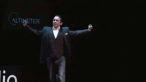 a man in a suit is dancing in front of a sign that says altimeter