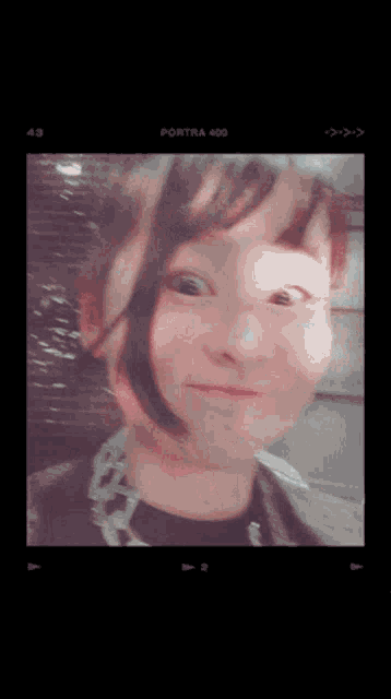 a woman 's face is shown in a portra 400 photo