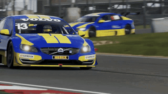 a blue and yellow volvo race car with number 13 on the front