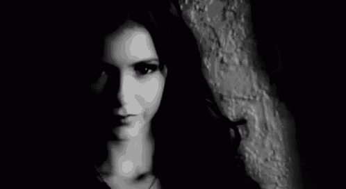 it is a black and white photo of a woman 's face .