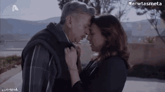 a man and a woman are hugging and kissing each other
