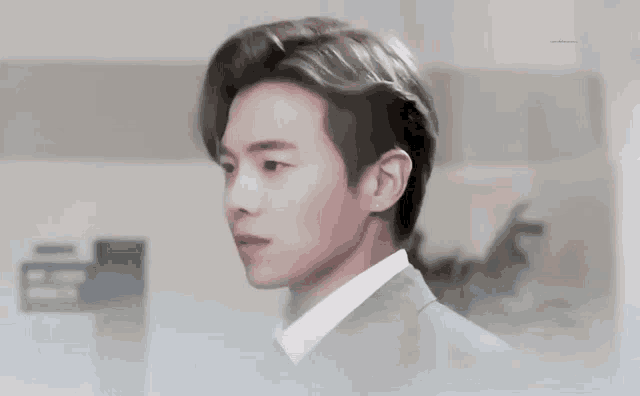 a man in a suit and white shirt is looking at the camera .