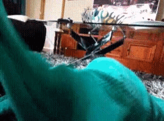 a statue of liberty is sitting in a living room next to a glass coffee table