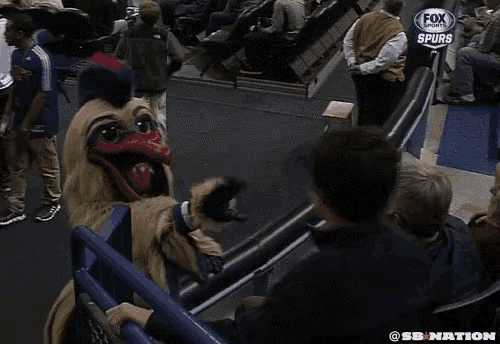 a mascot for the fox sports spurs talks to a man