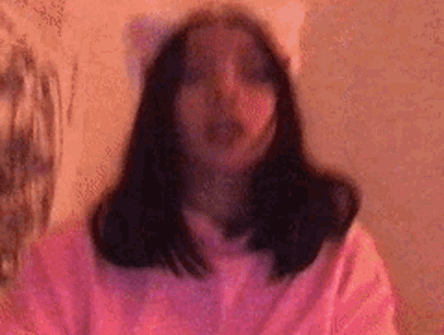 a blurry picture of a woman wearing a cat ear headband .