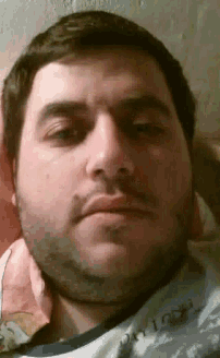 a man with a beard is wearing a shirt that says ' oasis ' on it