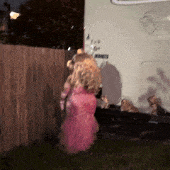 a woman in a pink dress is standing in front of a trailer that says rv on it