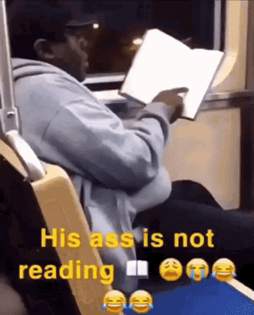 a man is reading a book while sitting on a bus and the caption says his ass is not reading