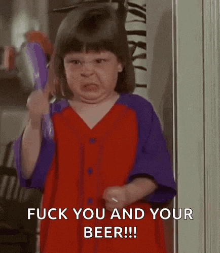 a little girl in a red and purple dress is holding a purple object and making a face .