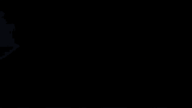 a close up of a person 's face in a dark room with a blurred background .