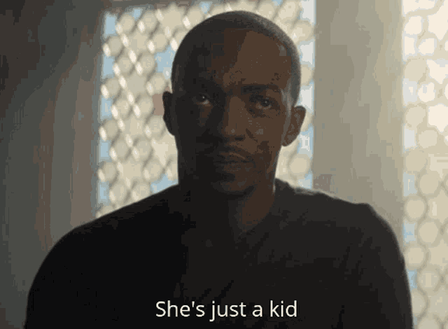 a man says she 's just a kid and looks at the camera