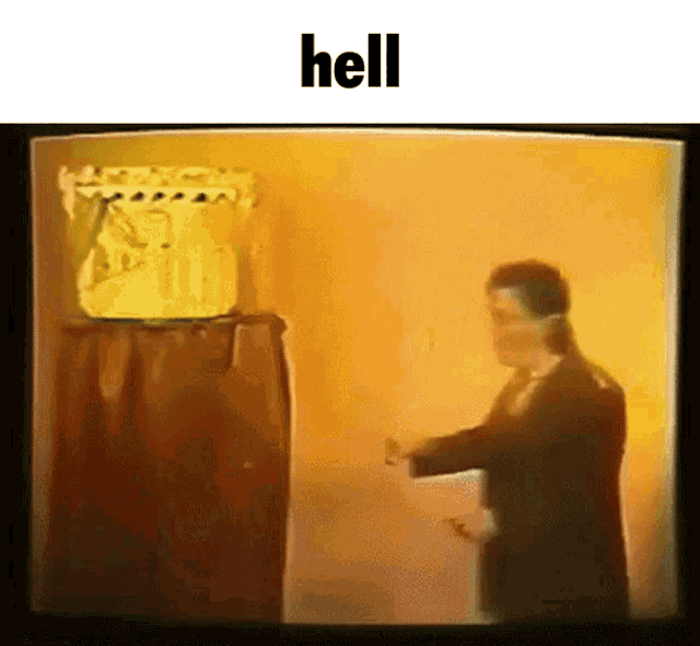 a man in a suit is standing in front of a podium with the words hell above him .