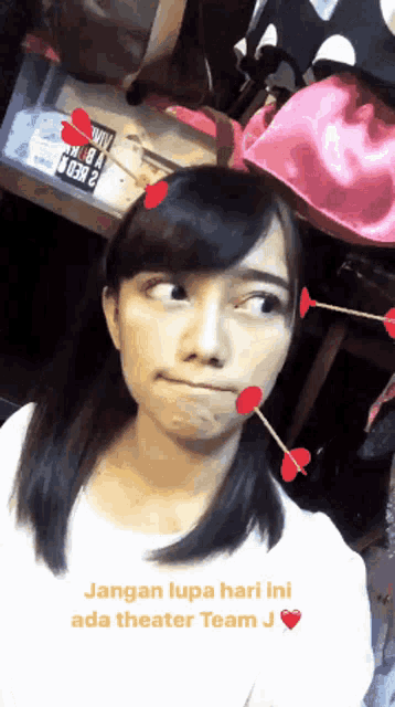 a girl with arrows in her face and the words jangan lupa hari ini ada theater team j on the bottom