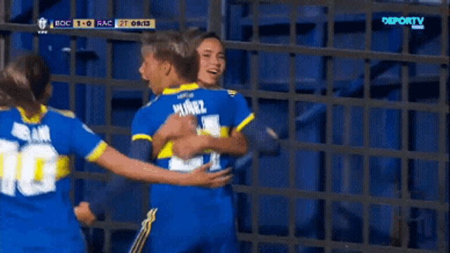 a soccer player wearing a number 10 jersey is hugging her teammate