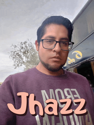 a man wearing glasses and a purple shirt that says jhazz on it