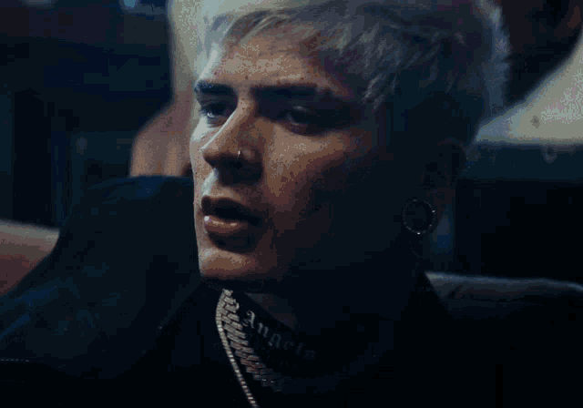 a close up of a person 's face with a tattoo that says angels