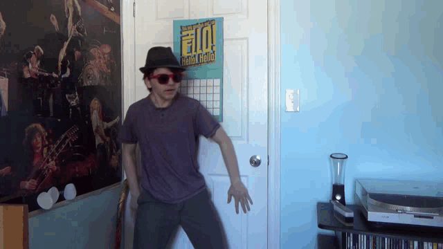 a man is dancing in front of a poster that says hello hello