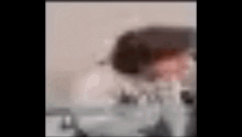 a blurry picture of a person 's face behind a glass .