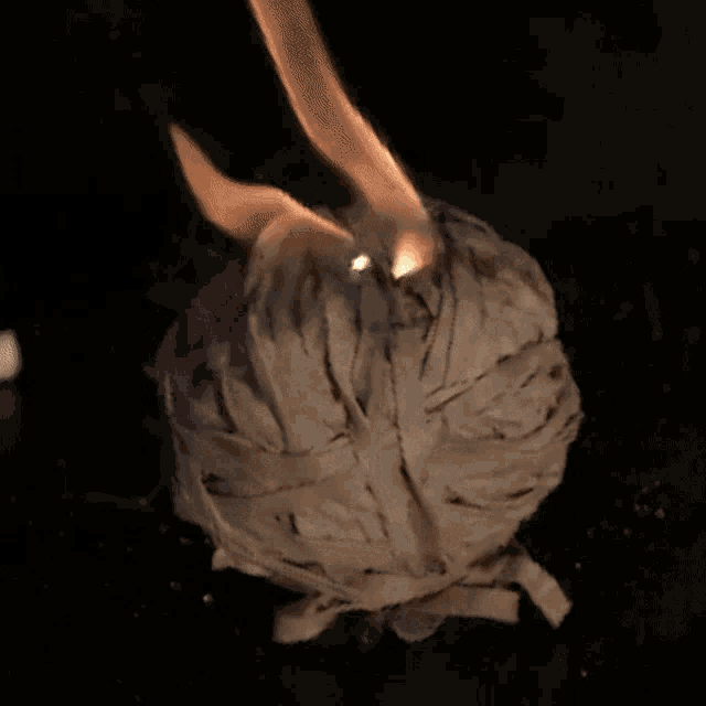 a ball of white rubber bands is burning in the dark
